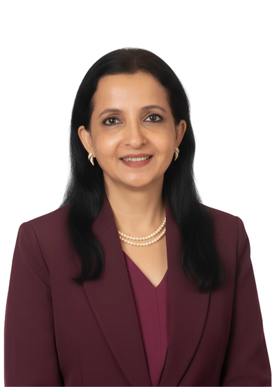 A professional headshot of a woman with long black hair, wearing a dark burgundy blazer over a matching burgundy top, accessorized with a double-strand pearl necklace and gold hoop earrings, set against a plain white background.